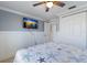 Comfortable bedroom with tile floors, a ceiling fan, and stylishly appointed closet and built-ins for optimal storage at 415 63Rd St, Holmes Beach, FL 34217