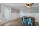 Bright dining area with a wooden table and four modern blue chairs, complemented by tile flooring and modern decor at 415 63Rd St, Holmes Beach, FL 34217