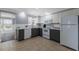 Modern kitchen featuring two-tone cabinetry, stainless steel appliances, and ample counter space for food preparation at 415 63Rd St, Holmes Beach, FL 34217