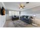 Cozy living room with plantation shutters, tiled floors, a ceiling fan, and comfortable seating area with contemporary decor at 415 63Rd St, Holmes Beach, FL 34217