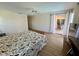Bedroom featuring ceiling fan, wood floors, and sliding glass doors with access to outdoor patio at 417 Firethorn Ave, Englewood, FL 34223
