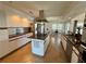 Bright kitchen features tile floors, granite countertops, stainless hood, and center island with cooktop at 417 Firethorn Ave, Englewood, FL 34223