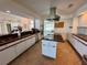 Open concept kitchen features granite counters, white cabinets, tile floors, and stainless appliances at 417 Firethorn Ave, Englewood, FL 34223