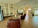 Bright living room with vaulted ceilings, tiled floors and large built-in shelves, perfect for displaying decor at 417 Firethorn Ave, Englewood, FL 34223