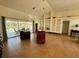 Open living room with tile flooring, ceiling fan, and sliding glass doors leading to the patio at 417 Firethorn Ave, Englewood, FL 34223