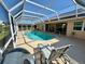 Beautiful in-ground swimming pool with a screened enclosure and a patio with furniture at 417 Firethorn Ave, Englewood, FL 34223