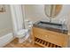 Well-lit bathroom featuring a modern vanity, toilet, and shower with stylish wooden-look flooring at 4375 Trails Dr # 17-1, Sarasota, FL 34232
