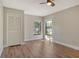 A sunlit bedroom with hardwood floors and two large windows offering charming neighborhood views at 4375 Trails Dr # 17-1, Sarasota, FL 34232