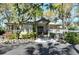 Inviting clubhouse entrance with well-maintained landscaping and visible community signage at 4375 Trails Dr # 17-1, Sarasota, FL 34232