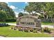The Lakes community sign with beautiful landscaping and flowers on a sunny day at 4375 Trails Dr # 17-1, Sarasota, FL 34232