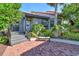 Charming home featuring a brick entry, gray wood siding, and mature landscaping for added privacy at 4375 Trails Dr # 17-1, Sarasota, FL 34232