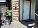 Inviting front porch with a decorative plant, birdhouse, and a welcoming door mat at 4375 Trails Dr # 17-1, Sarasota, FL 34232