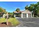 A two-car garage with a driveway and well-kept landscaping in a sunny, beautiful community at 4375 Trails Dr # 17-1, Sarasota, FL 34232