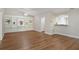 Spacious living room featuring hardwood floors, a large built-in bookshelf, and abundant natural light at 4375 Trails Dr # 17-1, Sarasota, FL 34232