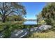 Picturesque pond surrounded by lush greenery and mature trees, creating a serene landscape at 4375 Trails Dr # 17-1, Sarasota, FL 34232