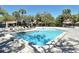 Community pool surrounded by lounge chairs and tropical palm trees, perfect for relaxation at 4375 Trails Dr # 17-1, Sarasota, FL 34232