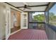 Relaxing screened porch with outdoor ceiling fan, a wood deck, and a view of the community at 4375 Trails Dr # 17-1, Sarasota, FL 34232