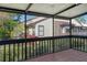 Screened porch with brown wood deck and views of the neighborhood landscaping at 4375 Trails Dr # 17-1, Sarasota, FL 34232