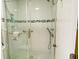 Modern bathroom shower with tiled walls, a glass door, and contemporary fixtures at 4375 Trails Dr # 17-1, Sarasota, FL 34232