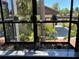 Close-up of a bright window showcasing decorative plants and a lovely outdoor view at 4375 Trails Dr # 17-1, Sarasota, FL 34232