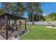 A tranquil backyard with a gazebo, potted plants, and a comfy swing set, perfect for relaxing and unwinding at 4619 20Th W Ave, Bradenton, FL 34209