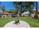 A spacious backyard featuring a fire pit, seating, and colorful kayaks creating an inviting outdoor space at 4619 20Th W Ave, Bradenton, FL 34209