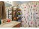 Bathroom with granite countertops, shelving unit and playful Snoopy themed shower curtain at 4619 20Th W Ave, Bradenton, FL 34209