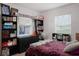 Comfortable bedroom with bookshelves and a cozy purple comforter at 4619 20Th W Ave, Bradenton, FL 34209