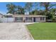 Single-story home with a well-maintained lawn and rock landscaping at 4619 20Th W Ave, Bradenton, FL 34209