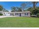 Charming single-story home with a well-manicured lawn and blue skies at 4619 20Th W Ave, Bradenton, FL 34209