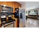 A kitchen featuring stainless steel appliances and a view into the living room at 4619 20Th W Ave, Bradenton, FL 34209