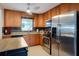 A kitchen featuring stainless steel appliances, granite countertops, and wooden cabinets at 4619 20Th W Ave, Bradenton, FL 34209