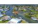 Aerial view of waterfront homes and canals, with lush landscapes, capturing the essence of a relaxed coastal community at 4704 Coral Lake Dr, Bradenton, FL 34210
