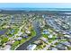 Scenic aerial view with sprawling waterfront homes nestled along canals, lush greenery, and coastal beauty creates a unique boating community at 4704 Coral Lake Dr, Bradenton, FL 34210