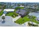 Aerial view features a home with manicured lawn, cul-de-sac street, and views of the surrounding neighborhood at 4704 Coral Lake Dr, Bradenton, FL 34210