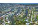 Stunning aerial view of a waterfront community with canal access and lush landscaping throughout the neighborhood at 4704 Coral Lake Dr, Bradenton, FL 34210