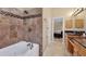 Bathroom featuring a soaking tub, tiled shower and wooden cabinets at 4704 Coral Lake Dr, Bradenton, FL 34210
