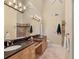 Bathroom with double sinks, granite countertops and a large mirror at 4704 Coral Lake Dr, Bradenton, FL 34210
