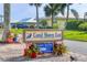Welcome to Coral Shores East, a deed restricted community entrance sign surrounded by vibrant flowers and landscaping at 4704 Coral Lake Dr, Bradenton, FL 34210