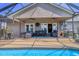 Well-lit patio area featuring comfortable seating and access to the pool, great for outdoor gatherings at 4704 Coral Lake Dr, Bradenton, FL 34210