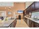 Well-lit kitchen with granite countertops, stainless steel appliances, and dark wood cabinets for storage at 4704 Coral Lake Dr, Bradenton, FL 34210