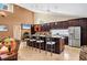 Gourmet kitchen with dark wood cabinets, granite countertops, stainless steel appliances, and breakfast bar at 4704 Coral Lake Dr, Bradenton, FL 34210