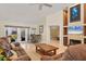 A spacious living room provides access to the lanai, features neutral paint, and flows into the dining area at 4704 Coral Lake Dr, Bradenton, FL 34210