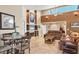 Open-concept living room featuring travertine floors, a fireplace, and comfortable seating at 4704 Coral Lake Dr, Bradenton, FL 34210