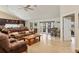 Spacious living room featuring tile floors, ceiling fan, and access to the outdoor living space at 4704 Coral Lake Dr, Bradenton, FL 34210