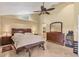 Comfortable main bedroom with a ceiling fan and ensuite bathroom at 4704 Coral Lake Dr, Bradenton, FL 34210