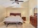 Comfortable main bedroom featuring neutral walls, a ceiling fan and a tile floor at 4704 Coral Lake Dr, Bradenton, FL 34210