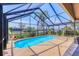 Enclosed pool area showcasing a sparkling pool with a screened enclosure, perfect for relaxation and enjoying the outdoors at 4704 Coral Lake Dr, Bradenton, FL 34210