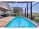 Stunning pool inside screened lanai with access to the covered patio and outdoor seating area at 4704 Coral Lake Dr, Bradenton, FL 34210