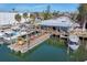 Charming waterfront restaurant with outdoor seating, wooden docks, and boats docked along the pier at 4704 Coral Lake Dr, Bradenton, FL 34210